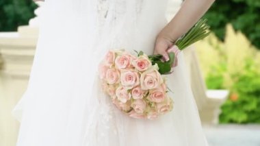 beautiful vintage style wedding bouquet in the hand of teh bride.