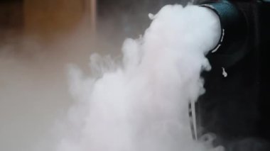 Smoke created with an electric fog machine on an empty stage. Smoke machine on a stage.