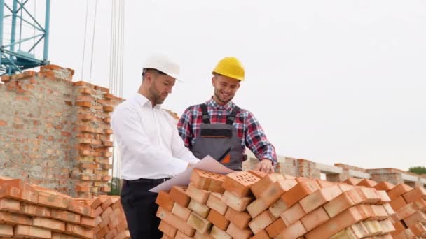 Dois Trabalhadores Construção Olham Para Desenho Arquitetônico Construção Casa — Vídeo de Stock