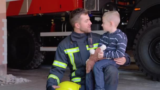 Brave Firefighter Uniform Holding Little Saved Boy Background Fire Engine — Stock Video