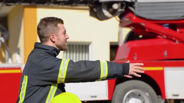Brave Firefighter Uniform Hugs Little Boy Toy Fire Engine — Stock Video