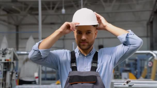 在工厂里 体力劳动者身穿制服 头戴安全帽 显得很有自信 — 图库视频影像