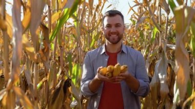 Yakışıklı bir çiftçi mısır hasat portresi.