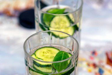 Vegan drink of water, cucumber and basil made for summer that helps keep water intake 