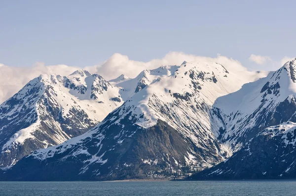 Snow Caped Mountains and the Sea Stock Photo
