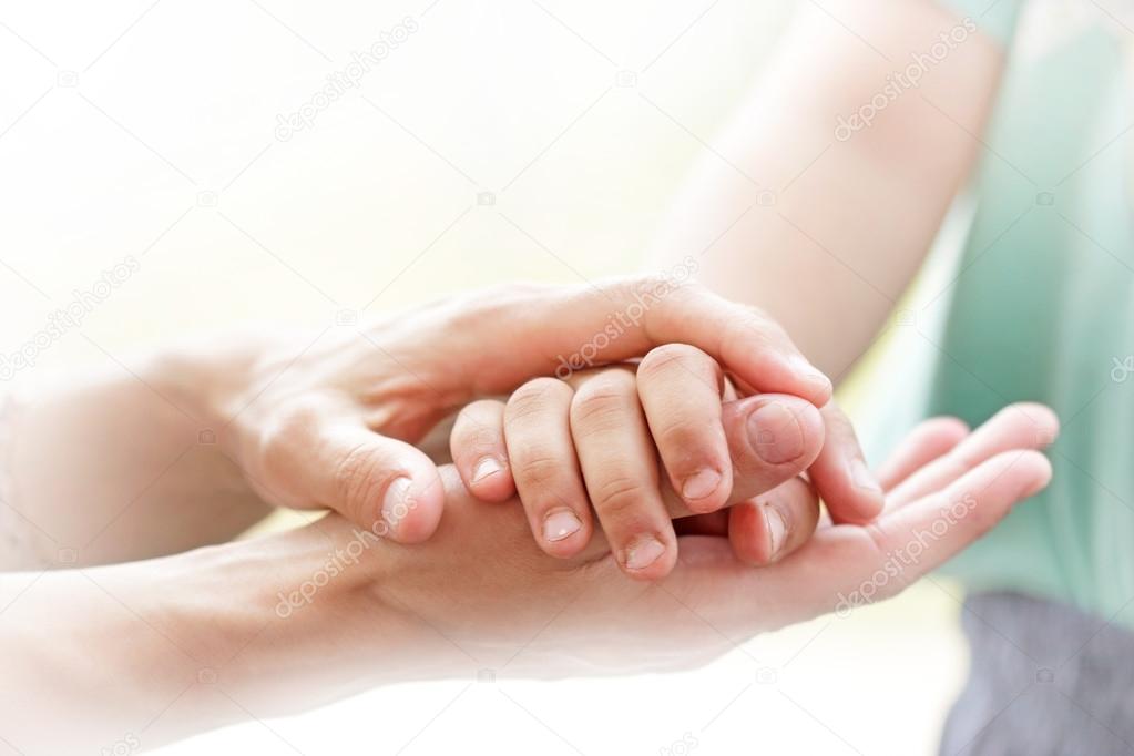 Mother holding a hands of her son