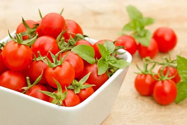 Tomate cereja em uma tigela na mesa — Fotografia de Stock