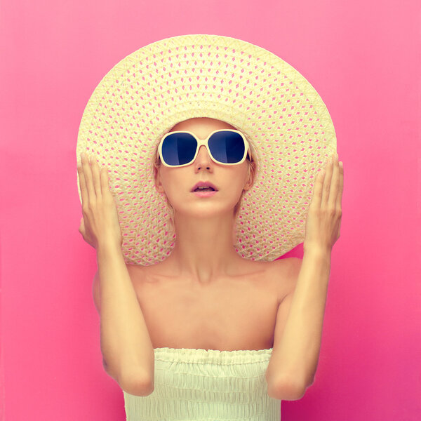 портрет девушки в шляпе на розовом фоне
