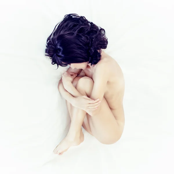 Portrait of a girl in white bed — Stock Photo, Image