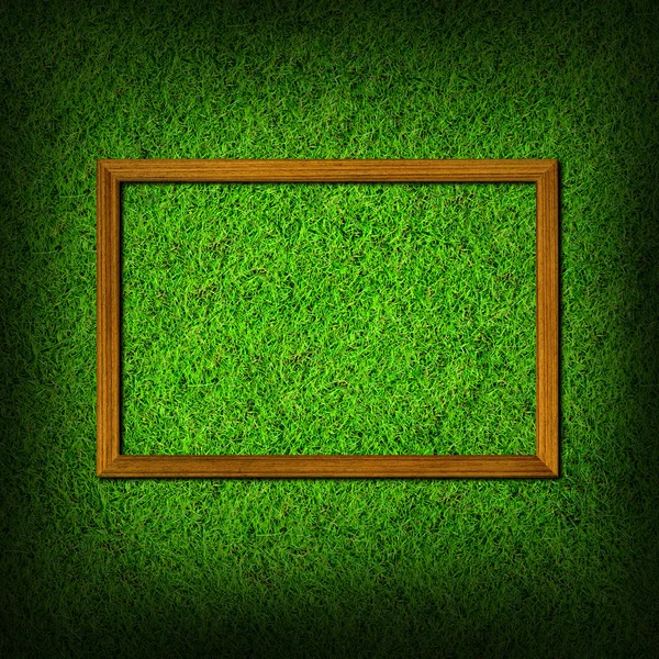 Wood frame on green grass field — Stock Photo, Image