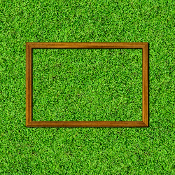 Wood frame on green grass field — Stock Photo, Image