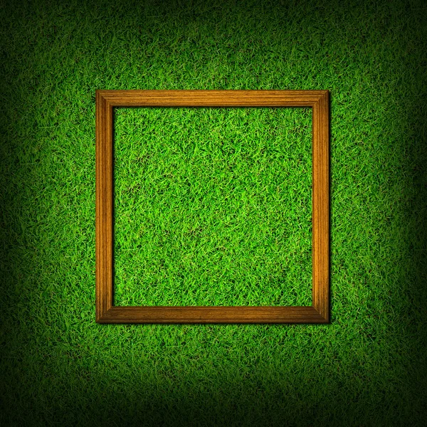 Wood frame on green grass field — Stock Photo, Image