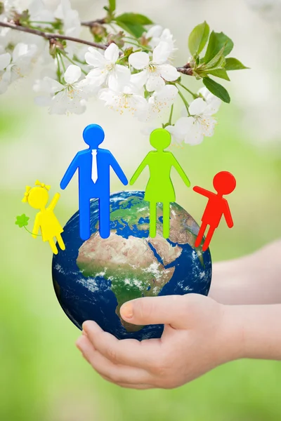 Earth with family in childrens hands — Stock Photo, Image