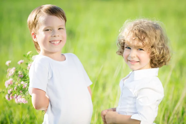 Happy children with flowers — Stok fotoğraf