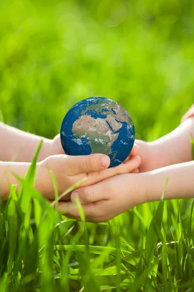 Earth in childrens hands — Stock Photo, Image