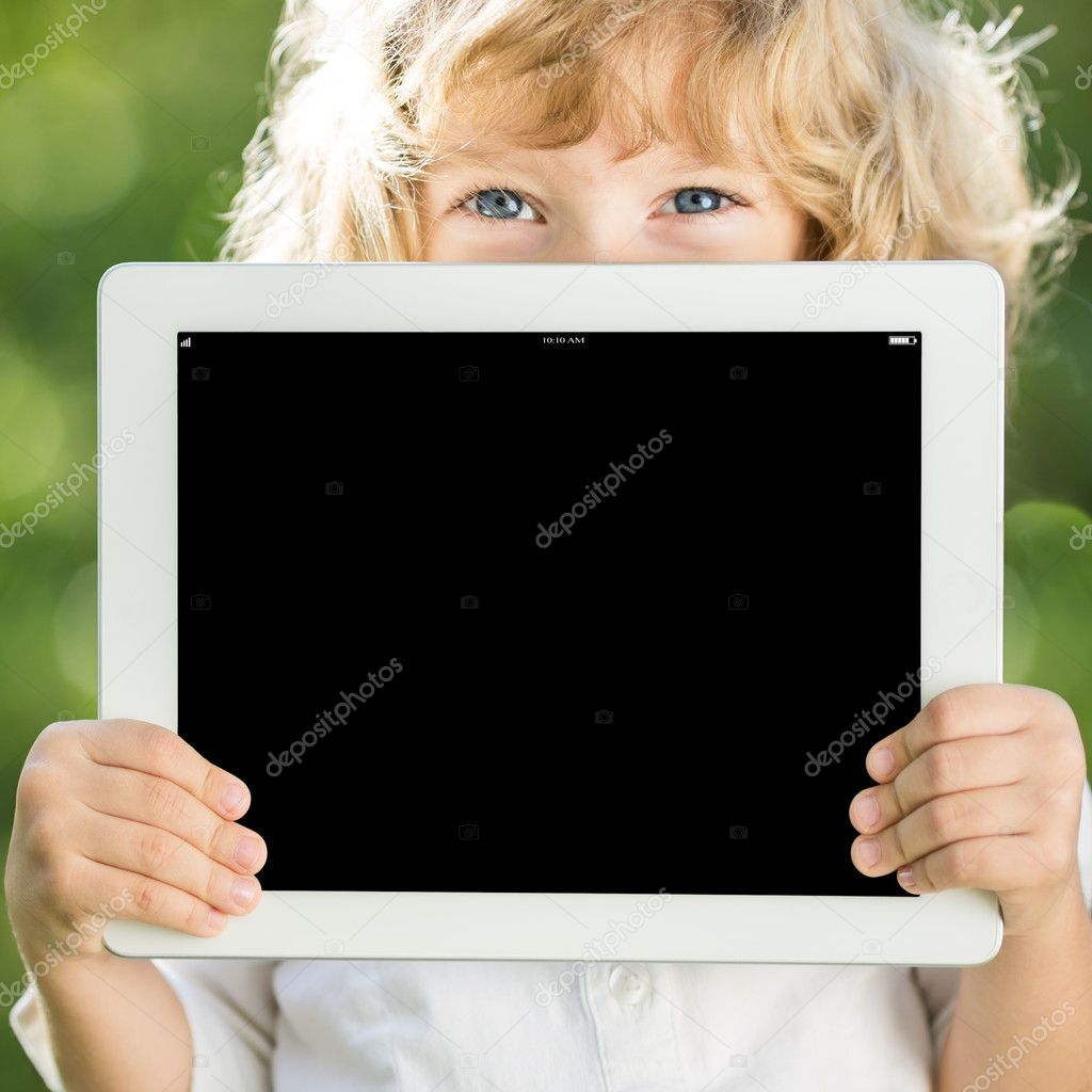Child holding tablet PC Stock Photo by ©Yaruta 21384503