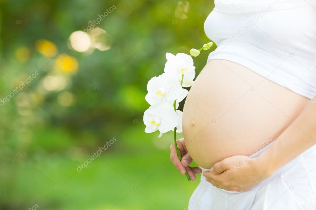 Beautiful belly of young pregnant woman