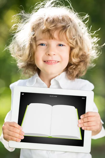 Child holding tablet PC with ebook — Stock Photo, Image