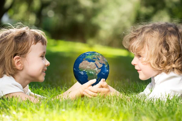 Earth in childrens hands — Stock Photo, Image