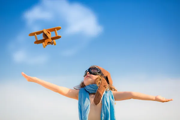 Happy kid playing with toy airplane — Stock Photo, Image