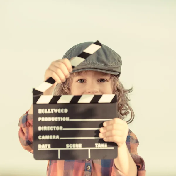 Kid holding clapper board in hands — Stock Photo, Image