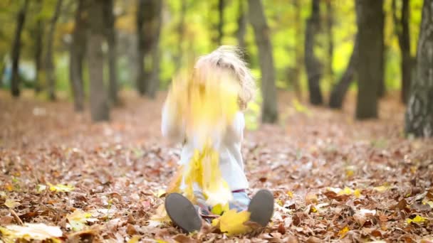 Happy child playing outdoors in autumn park — Stock Video