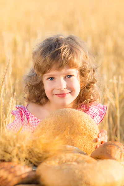 Happy child holding bread — Stock Photo, Image