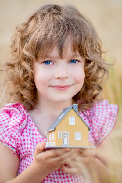 Child holding house in hands