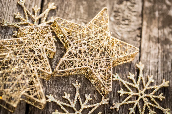 Gold Christmas tree decorations on grunge wood — Stock Photo, Image