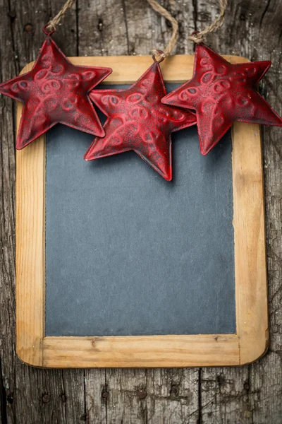 Christmas tree decorations border on vintage wooden blackboard — Stock Photo, Image