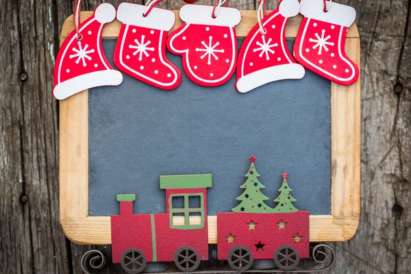 Christmas tree decorations border on vintage wooden blackboard — Stock Photo, Image