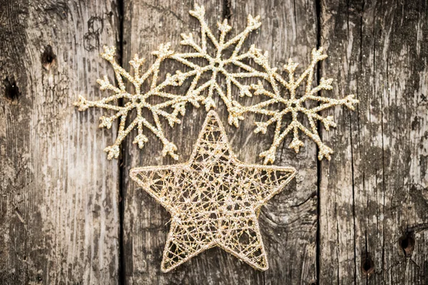 Gold Christmas tree decorations on grunge wood — Stock Photo, Image