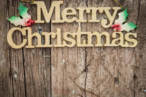 Zlaté text "merry christmas" na dřevo — Stock fotografie
