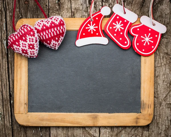 Christmas tree decorations on vintage wooden blackboard — Stock Photo, Image