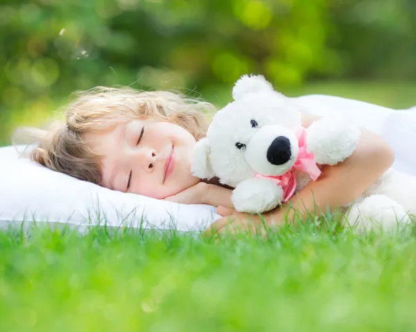 Niño durmiendo en el jardín de primavera — Foto de Stock