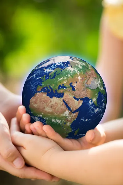 Children holding Earth in hands — Stock Photo, Image