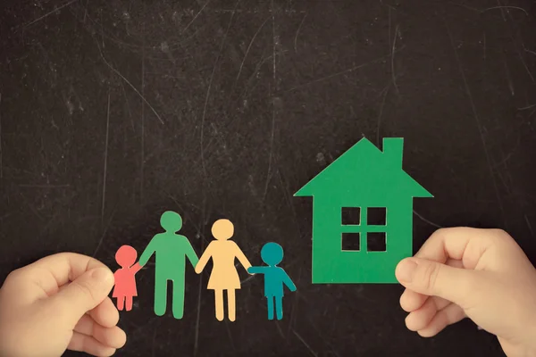 Paper family and house in hands — Stock Photo, Image