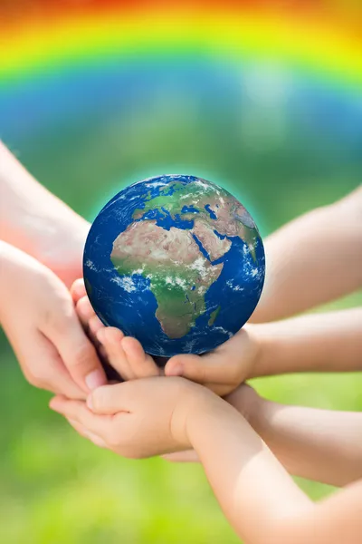 Children holding Earth in hands — Stock Photo, Image