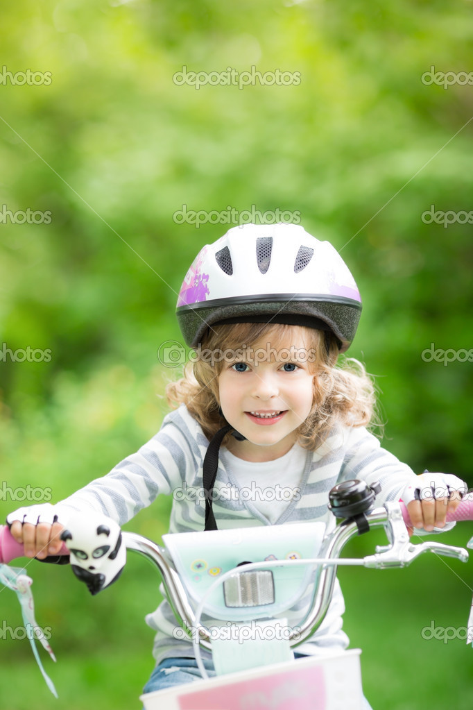 Happy kid sitting on the bike