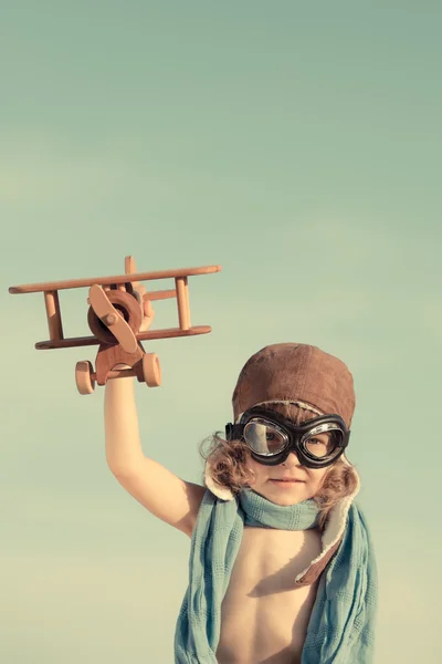 Happy kid playing with toy airplane — Stock Photo, Image