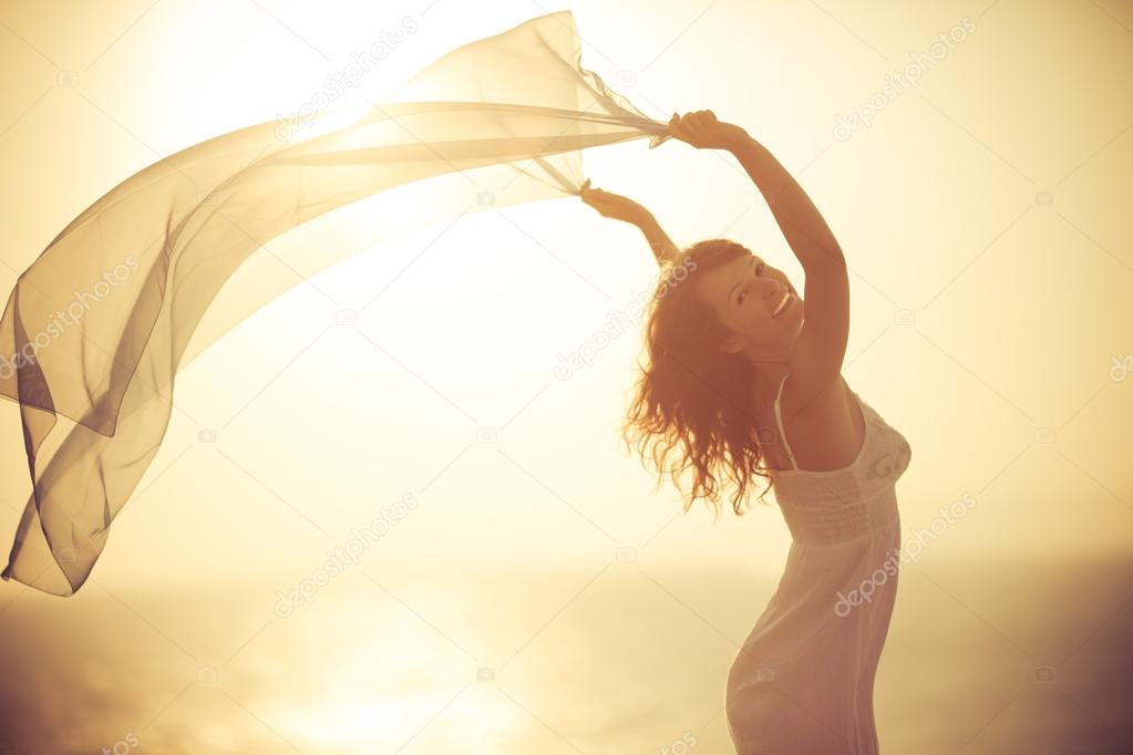 Silhouette of young woman relaxing at the beach