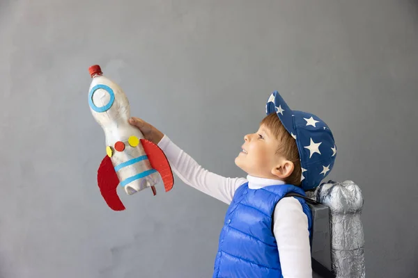 Happy Child Playing Toy Rocket Concrete Wall Background Kid Pretend — Stock Photo, Image