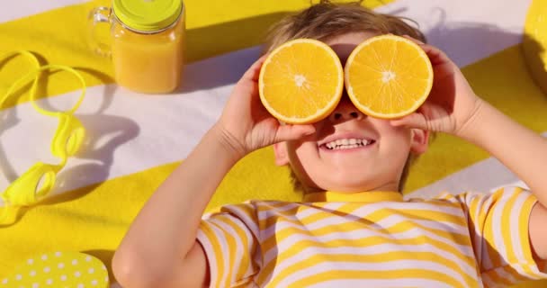 Happy Child Holding Halves Orange Fruit Sunglasses Funny Kid Lying — Vídeo de Stock