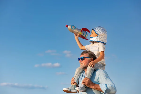 夏の空を背景にしたシニア男性と子供の屋外 祖父と少年は一緒に楽しんでいます 家族の休日の概念 幸せな父の日 — ストック写真