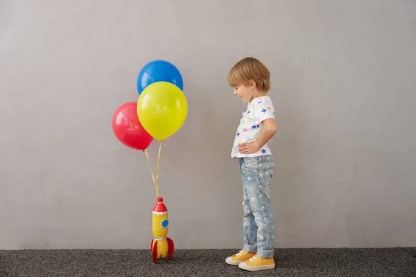 Szczęśliwe Dziecko Bawiące Się Zabawkową Rakietą Domu Dzieciak Udaje Astronautę — Zdjęcie stockowe