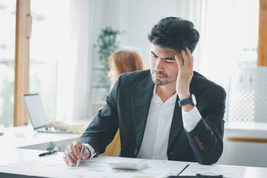 Young asian businessman feeling stressed in an office. Tired frustrated, Business problem failure concept