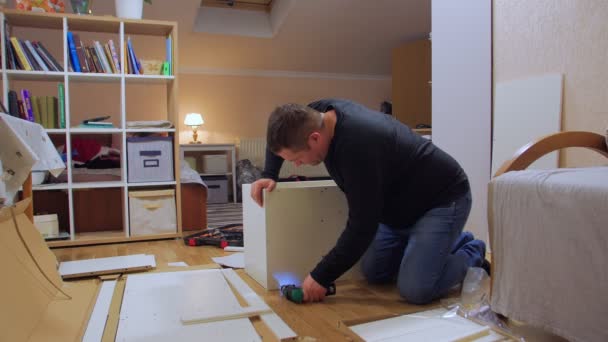 Man Assemble Furniture With Screwdriver — стоковое видео