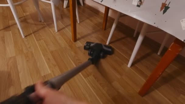 Vacuuming Under The Table — стоковое видео