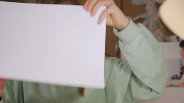 Girl Cuts Out Of Paper — Stockvideo