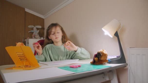 Girl Draws At Desk — стоковое видео